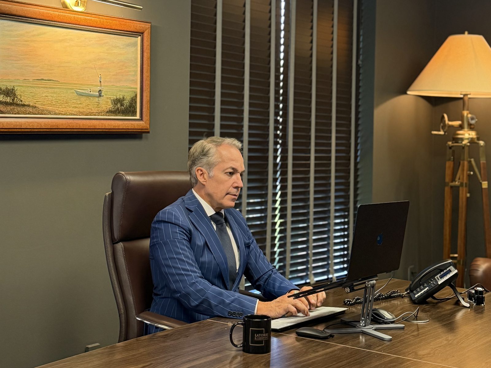 Albert F. Latorre working at his desk at the Latorre & Company office